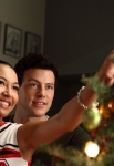 GLEE: Santana (Naya Rivera, L) and Finn (Cory Monteith, R) put the star on the Christmas tree in the "A Very Glee Christmas" episode of GLEE airing Tuesday, Dec. 7 (8:00-9:00 PM ET/PT) on FOX. ©2010 Fox Broadcasting Co. CR: Justin Lubin/FOX