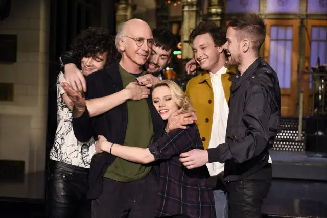 SATURDAY NIGHT LIVE -- "Larry David" Episode 1695 -- Pictured: (l-r) Matthew Healy, Ross MacDonald, George Daniel, and Adam Hann of musical guest The 1975 surround actor Larry David and actress Kate McKinnon on February 4, 2016 -- (Photo by: Dana Edelson/NBC)