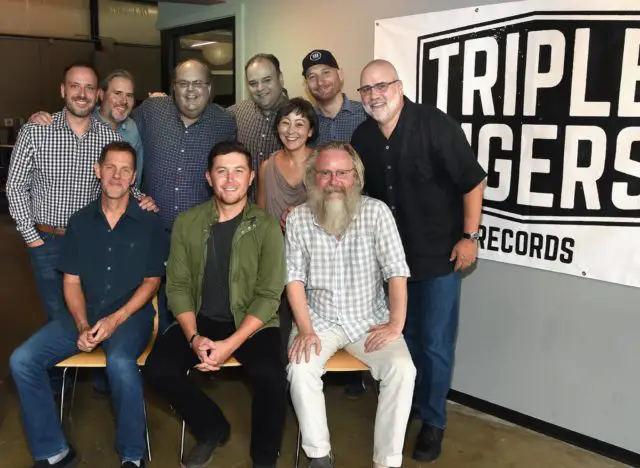 Scotty McCreery Signs Record Deal: Top Row L to R: Nate Towne (WME), David Boyer (FBMM), Scott Stem (Triple 8), David Crow (MHCRK), George Couri (Triple 8/ Triple Tigers), Nancy Quinn (Thirty Tigers), Kevin Herring (Triple Tigers) Bottom Row L to R: Norbert Nix (Triple Tigers), Scotty McCreery, David Macias (Thirty Tigers/ Triple Tigers)