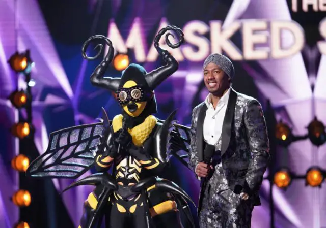 THE MASKED SINGER: L-R: Bee and host Nick Cannon in the “Touchy Feely Clues” episode of THE MASKED SINGER airing Wednesday, Feb. 6 (9:00-10:00 PM ET/PT) on FOX. © 2019 FOX Broadcasting. CR: Michael Becker / FOX.