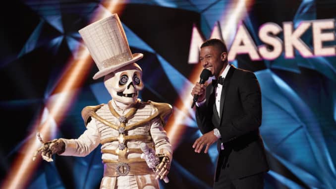 THE MASKED SINGER: L-R: The Skeleton and host Nick Cannon in the “Season Two Premiere” episode of THE MASKED SINGER airing Wednesday, Sept. 25 (8:00-10:00 PM ET/PT) on FOX.. © 2019 FOX MEDIA LLC. CR: Michael Becker / FOX.