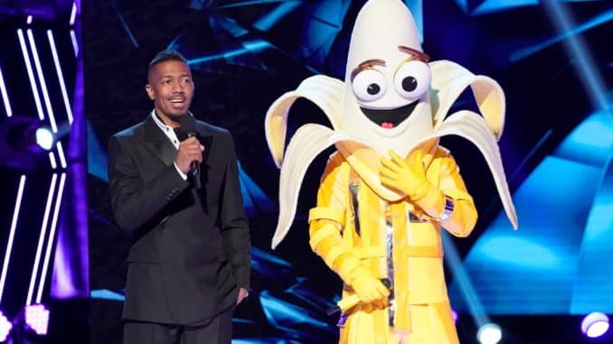 THE MASKED SINGER: L-R: Host Nick Cannon and The The Banana in the ?A Brand New Six Pack: Group B Kickoff!? episode of THE MASKED SINGER airing Wednesday, Feb 19 (8:00-9:01 PM ET/PT) on FOX. © 2020 FOX MEDIA LLC. CR: Greg Gayne / FOX.