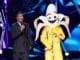THE MASKED SINGER: L-R: Host Nick Cannon and The The Banana in the ?A Brand New Six Pack: Group B Kickoff!? episode of THE MASKED SINGER airing Wednesday, Feb 19 (8:00-9:01 PM ET/PT) on FOX. © 2020 FOX MEDIA LLC. CR: Greg Gayne / FOX.