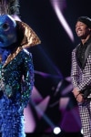 THE MASKED SINGER: L-R: Peacock and host Nick Cannon in the all-new “Five Masks No More” episode of THE MASKED SINGER airing Wednesday, Jan. 16 (9:00-10:00 PM ET/PT) on FOX. © 2019 FOX Broadcasting. CR: Michael Becker / FOX.