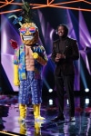 THE MASKED SINGER: L-R: Pineapple and host Nick Cannon in the "New Masks on the Block" episode of  THE MASKED SINGER airing Wednesday, Jan. 9 (9:00-10:00 PM ET/PT) on FOX. © 2019 FOX Broadcasting. CR: Michael Becker / FOX.