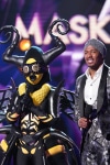 THE MASKED SINGER: L-R: Bee and host Nick Cannon in the “Touchy Feely Clues” episode of THE MASKED SINGER airing Wednesday, Feb. 6 (9:00-10:00 PM ET/PT) on FOX. © 2019 FOX Broadcasting. CR: Michael Becker / FOX.