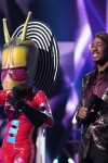 THE MASKED SINGER: L-R: Alien and host Nick Cannon in the “All Together Now” episode of THE MASKED SINGER airing Wednesday, Feb. 13 (9:00-10:00 PM ET/PT) on FOX. © 2019 FOX Broadcasting. Cr: Michael Becker / FOX.
