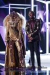 THE MASKED SINGER: L-R: Lion and host Nick Cannon in the “All Together Now” episode of THE MASKED SINGER airing Wednesday, Feb. 13 (9:00-10:00 PM ET/PT) on FOX. © 2019 FOX Broadcasting. Cr: Michael Becker / FOX.