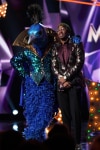 THE MASKED SINGER: L-R: Peacock and host Nick Cannon in the “All Together Now” episode of THE MASKED SINGER airing Wednesday, Feb. 13 (9:00-10:00 PM ET/PT) on FOX. Cr: Michael Becker / FOX.